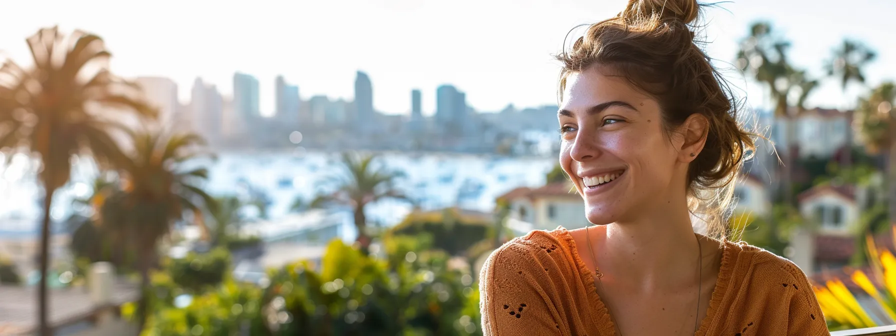 a homeowner in san diego smiling while reviewing mortgage refinancing options on a sunny patio overlooking the city skyline.