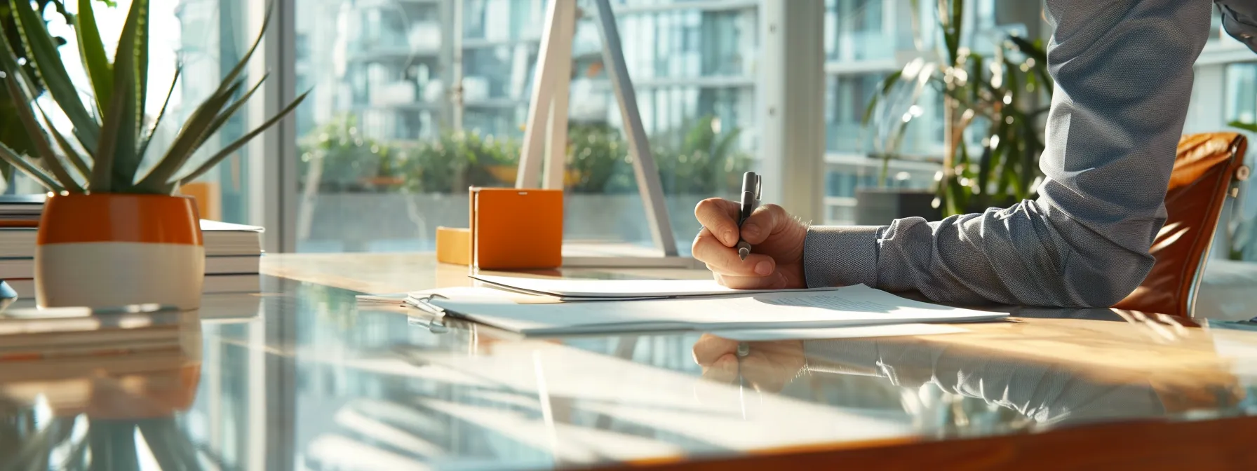 a person signing paperwork at a modern, sleek desk in a bright, airy office while discussing mortgage refinancing options in san diego.