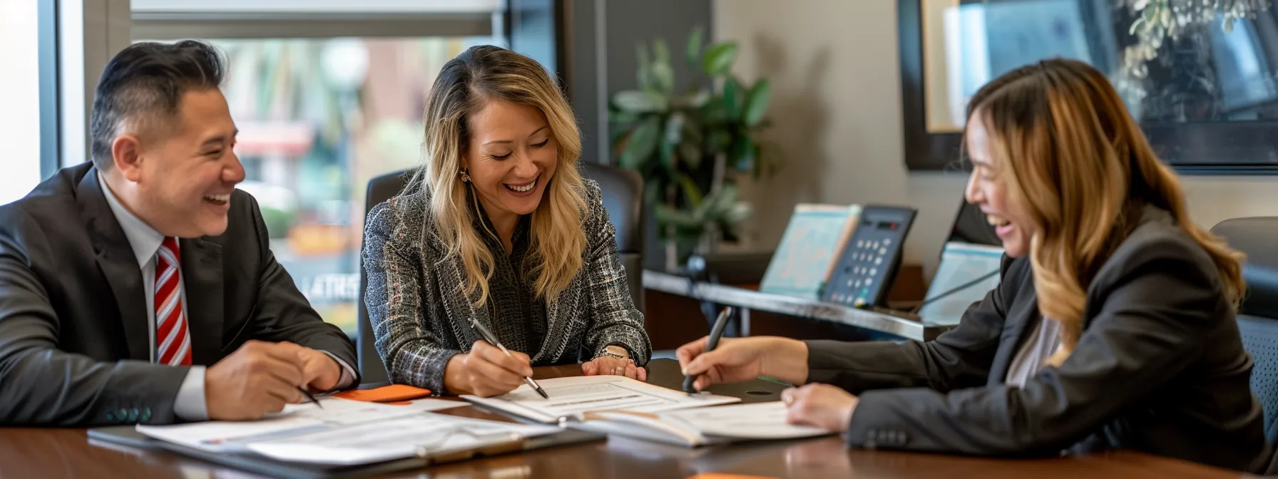 a couple happily signing paperwork with a smiling loan officer in a modern office setting in san diego, showcasing the benefits of refinancing their mortgage. a couple happily signing paperwork with a smiling loan officer in a modern office setting in san diego, showcasing the benefits of refinancing their mortgage.