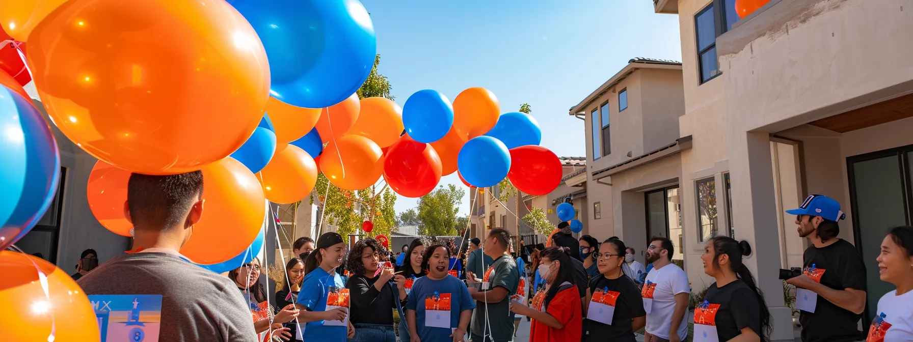 a diverse group of first-time homebuyers in san diego receiving keys to their new homes surrounded by colorful balloons and city-specific grant banners.