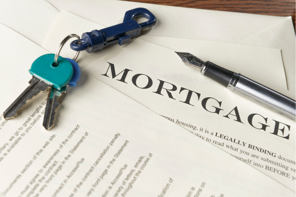 A close-up shot of mortgage documents featuring the word MORTGAGE in bold text, accompanied by a fountain pen and a set of house keys on a plastic clasp.