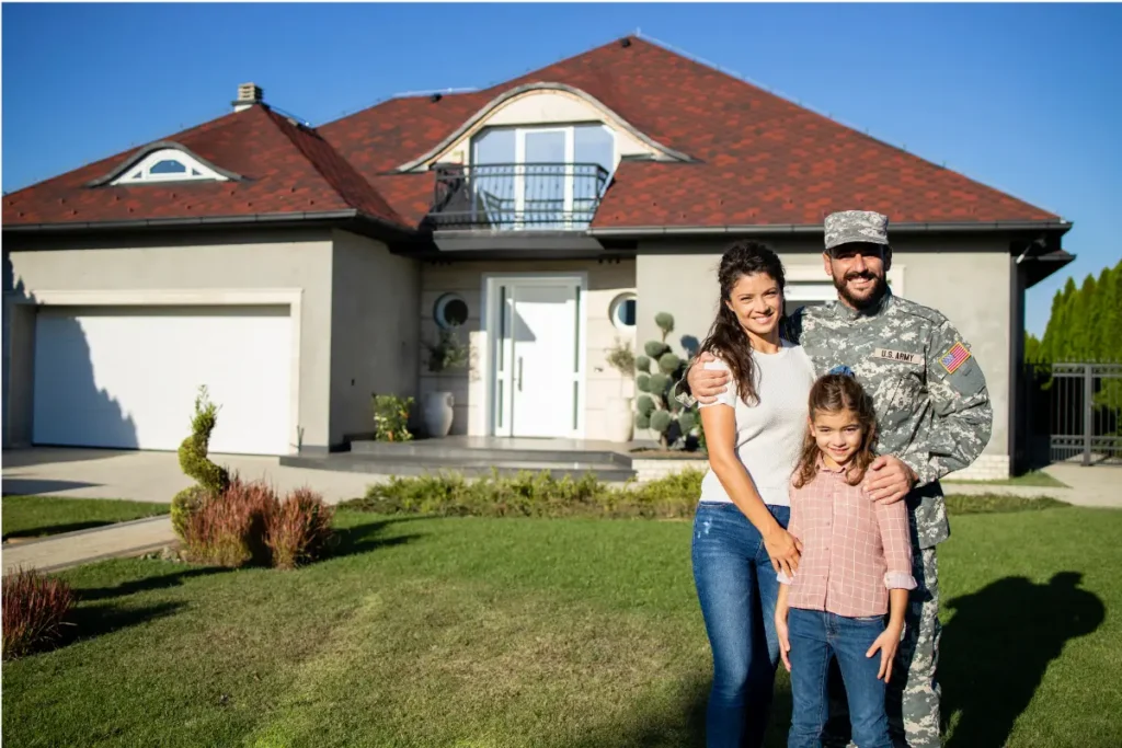 Portrait of happy american military family in front of their house.